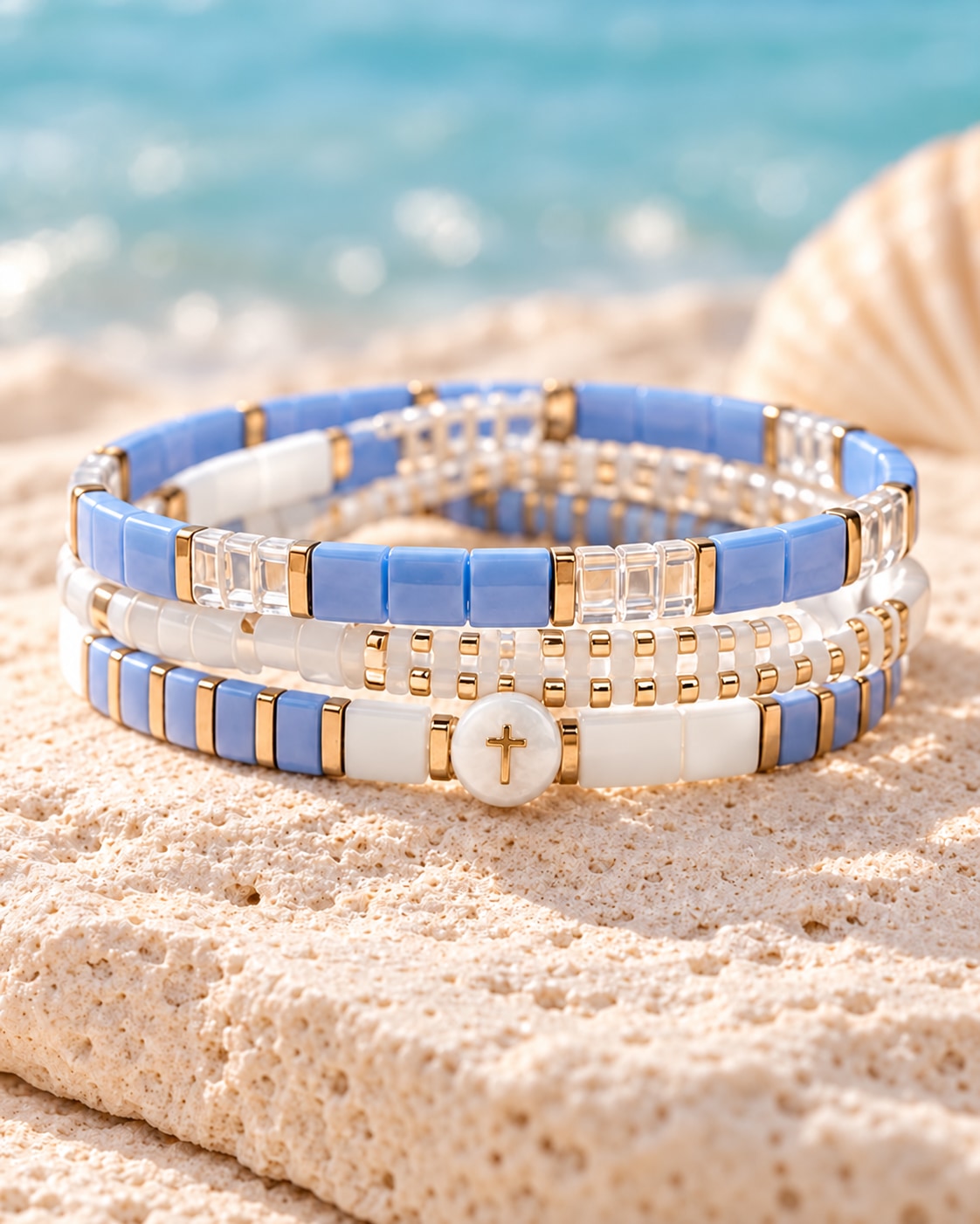 The Coastal Edit: blue and white bracelet strands with gold-tone accents and a round white cross bead.